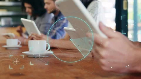 Three men in coffee shop using tablets, right angling tablet starting teal HUD Stock Footage 333553071