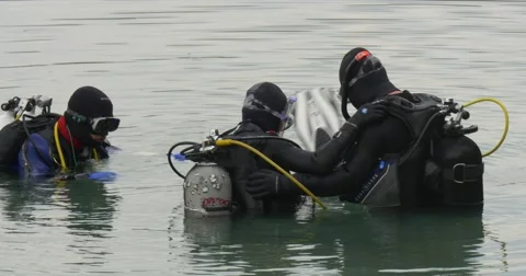 Three Men Divers Close Up Are Standing in The Water Going to Dive Checking Stock Footage 55102289