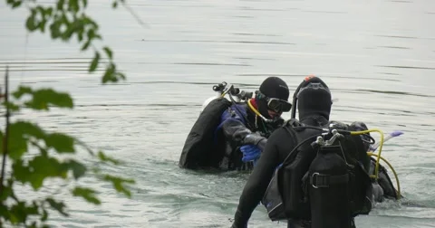 Three Men Divers in Swimsuits Are Standing in The Water Checking the Equipment Stock Footage 55100240