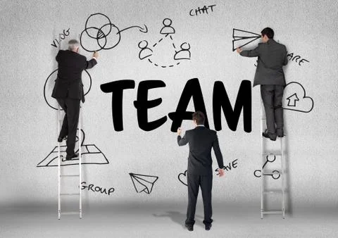 Three men drawing a graphic about team on a wall Stock Photos