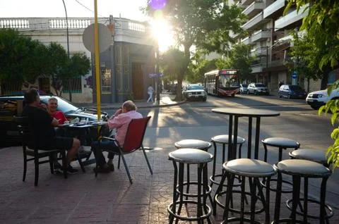 Three men drinking coffee in cafe outside on street Stock Photos
