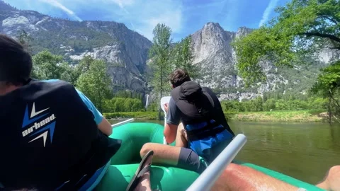 Three men float down a river in Yosemite National Park. There are two Stock Footage 197119806