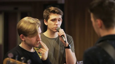 Three Men, One of Them is Singing to the Microphone Stock Footage 72225373