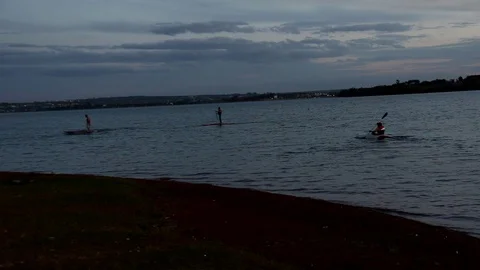 Three Men Padding a canoe on Paranoa Lake Stock Footage 115508011