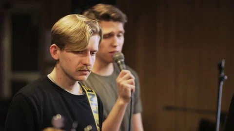 Three Men Playing Electric Guitars and a Vocalist Singing Stock Footage 72224717