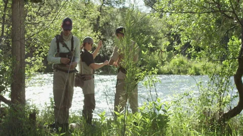 Three men preparing for fly fishing near the river 動画素材 59899326