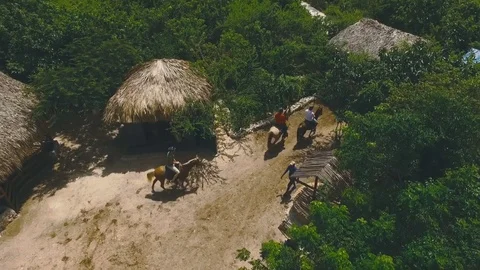 Three men ride horses from the stables Stock Footage 73828656