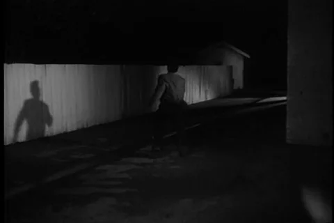 Three men running away from another man at night, 1960s Stock-Footage 90727730