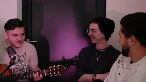 Three men sit, sing, play guitar. Recording studio, professional singers Stock Footage 194026738