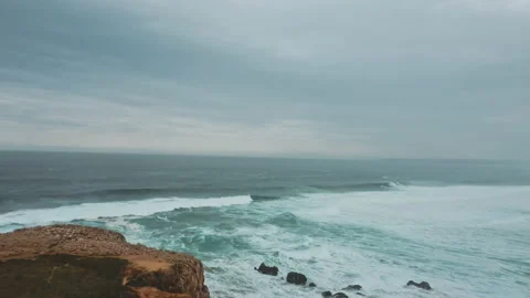 Three men sitting on top of van drone moves above them towards ocean Stock Footage 203598881