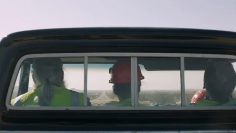 Three men sitting in vehicle and drive through the empty road Stock Footage 99046965