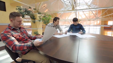 Three Men start up specialist discuss project at table Stock Footage 64188544