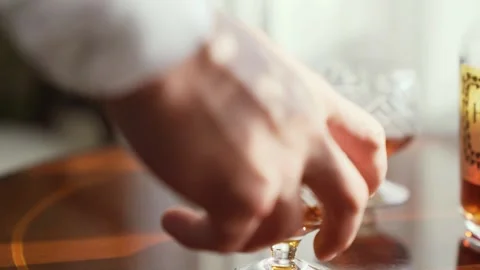 Three men take glasses of whiskey from the table in slow-motion Stock Footage 233712407