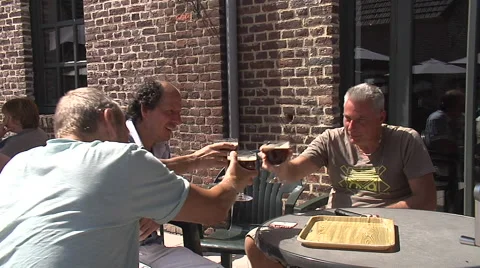 Three men toasting Belgian beer glasses, Belgium Stock Footage 49138920