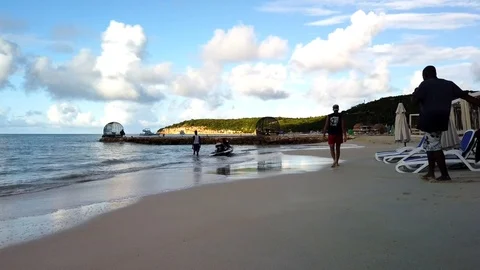 Three men walk with trailer prepare to load jet ski and pull out of water Stock Footage 124295533
