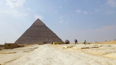 Three Men Walking Past Pyramids Stock Footage 146051096