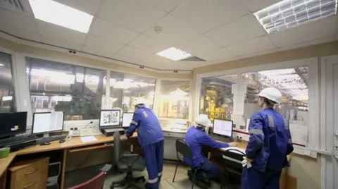 Three men work in room of control devices in workshop Video stock 32428756