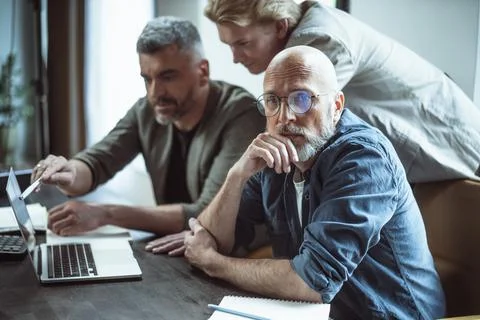 Three Men Working Together on Laptops Stock Photos