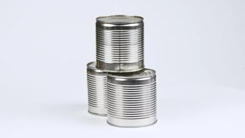Three metal cans on a white background. Side view. Loop motion. Stock Footage 245074291
