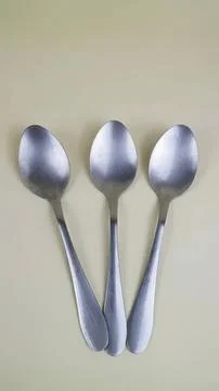 Three metal spoons on a light background Stock Photos