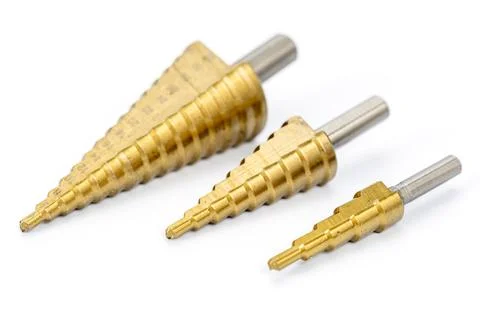 Three Metal Step Drill Bits in Various Sizes on White Background Stock Photos