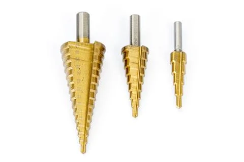 Three Metal Step Drill Bits in Various Sizes on White Background Stock Photos