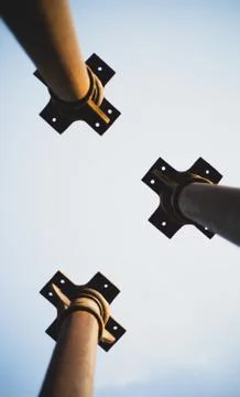 Three metallic pillars pointing the sky show from below during day Stock Photos
