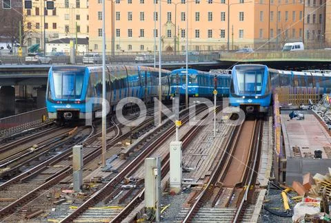 Three metro trains on the Gamla Stan Tunnelbanabron metro bridge, Stockholm Stock Photos