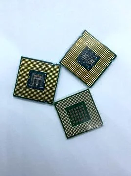Three microprocessors with pins up closeup view isolated on white background Stock Photos