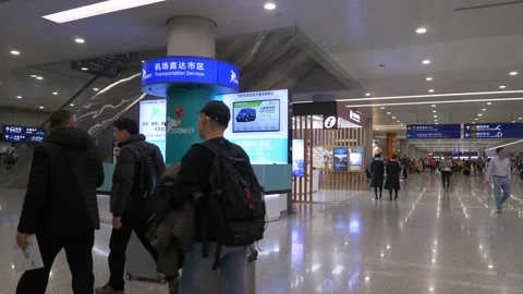 Three middle-aged men walking in Hong Kong airport with their luggage 動画素材 144817689