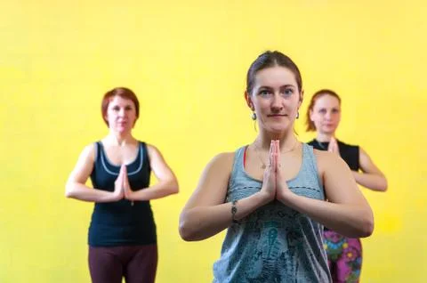 Three middle aged women practicing yoga in class Stock Photos