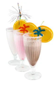 Three Milkshakes with Decorations on White Background Stock Photos