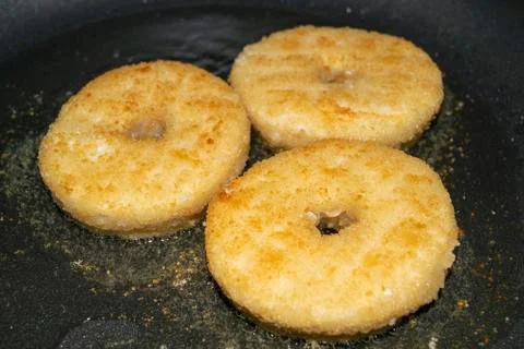 Three minced chicken cutlets are fried in a pan in vegetable oil. Close up. Stock Photos