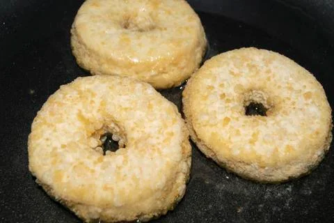 Three minced chicken cutlets are fried in a pan in vegetable oil. Close up. Stock Photos