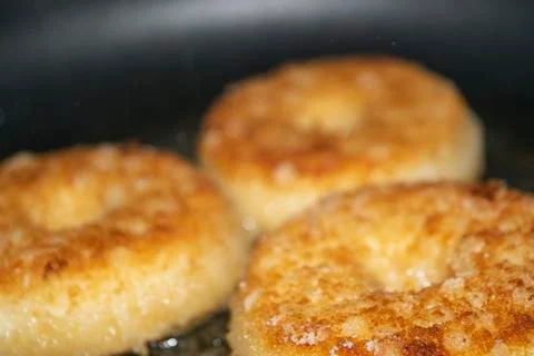 Three minced chicken cutlets are fried in a pan in vegetable oil. Close up. Stock Photos