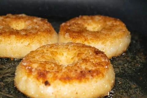 Three minced chicken cutlets are fried in a pan in vegetable oil. Close up. Stock Photos