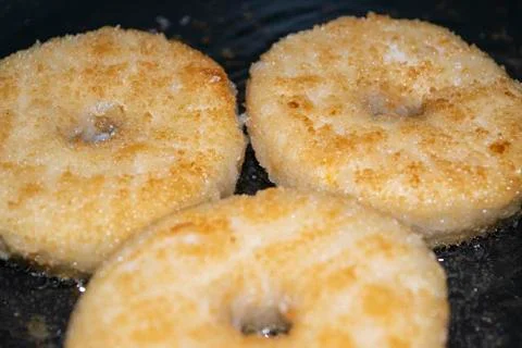 Three minced chicken cutlets are fried in a pan in vegetable oil. Close up. Stock Photos