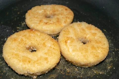 Three minced chicken cutlets are fried in a pan in vegetable oil. Close up. Stock Photos