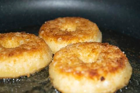 Three minced chicken cutlets are fried in a pan in vegetable oil. Close up. Stock Photos