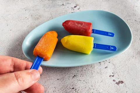 Three mini colored ice creams on white background Stock Photos