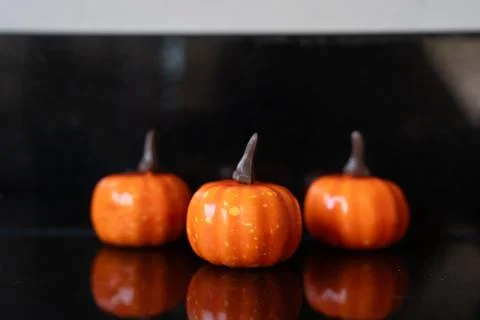 Three mini pumpkins on dark background Stock Photos