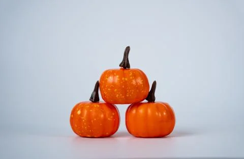 Three Mini Pumpkins on White Background. Autumn Harvest Decoration Stock Photos