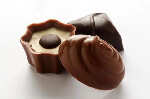 Three mixed chocolates on a white background Stock Photos