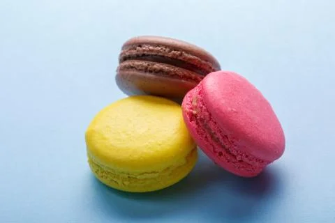 Three mixed colorful macarons over gray background Fotos Stock