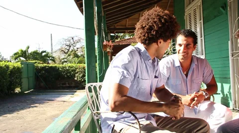 Three mixed race young men talking, laughing on porch, dolly shot Stock Footage 37371952
