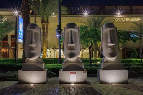 Three Moai statues illuminated at night at a cultural center on September 3, Stock Photos