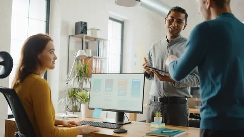 Three Mobile Software Developers Work on Desktop Computer, They Discuss Design Stock Footage 112601988
