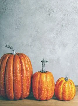 Three mock-up pumpkins on wooden table. Moody Style. Halloween concept. Aut.. Stock Photos