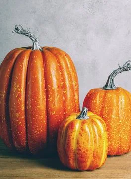 Three mock-up pumpkins on wooden table. Moody Style. Halloween concept. Aut.. Stock Photos