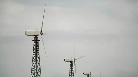 Three modern wind generators, cloudy grey sky bg Stock Footage 97101222